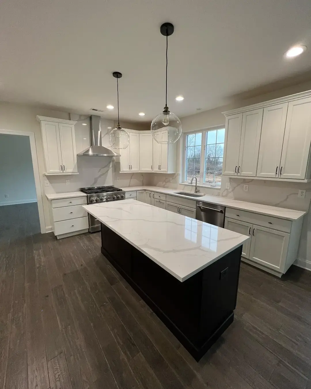 Completed kitchen with white cabinets and quartz counter tops