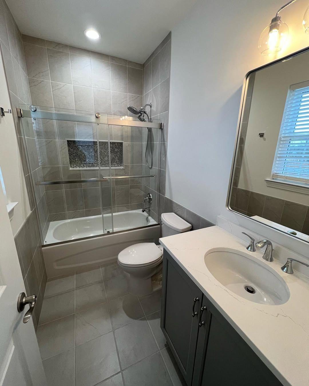 Completed bath with sink toilet and shower tub combo.